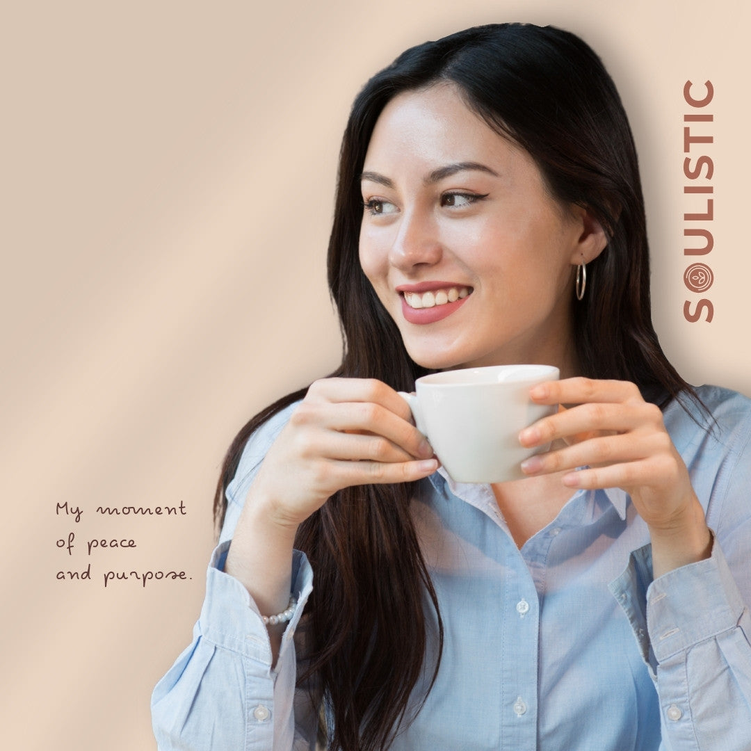 Celebrity smiling while looking to the right and holding Soulistic Coffee in hand