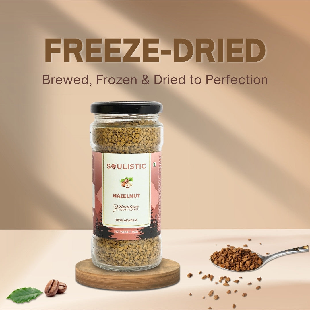Jar of freeze-dried Soulistic Hazelnuts Coffee with a spoonful of coffee on a beige background