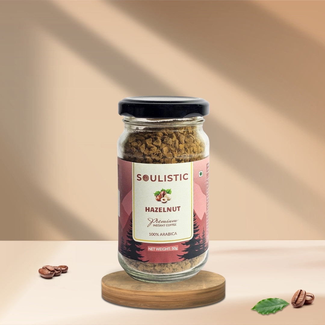 50g jar of Soulistic hazelnut coffee on a wooden coaster with a beige background