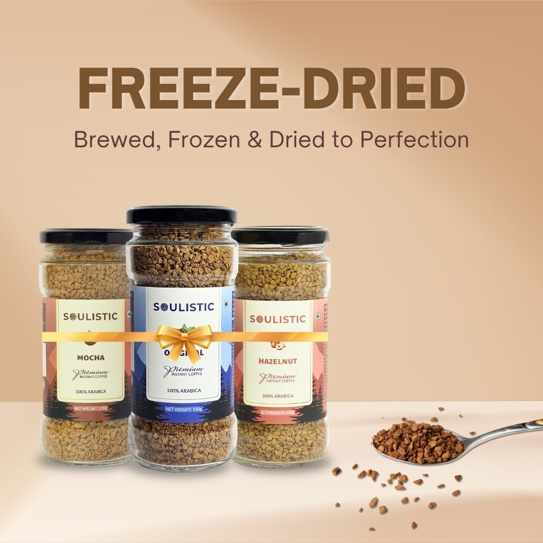 Three jars of Soulistic freeze-dried coffee with a spoonful of coffee on a beige background.