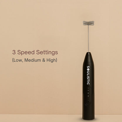 Black milk frother with 'Soulistic' branding on a beige background