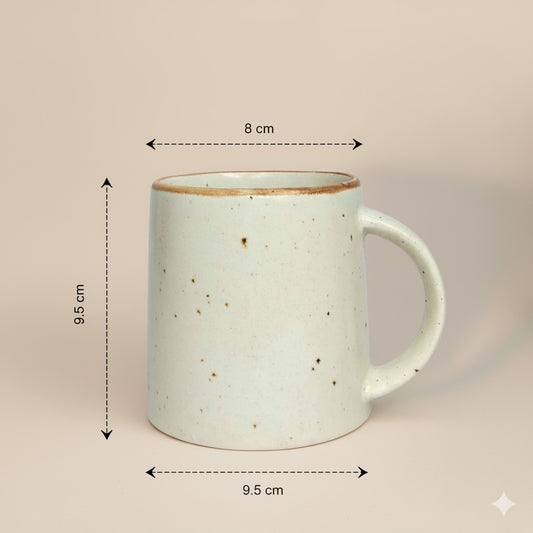 Stoneware mug with dimensions indicated on a beige background