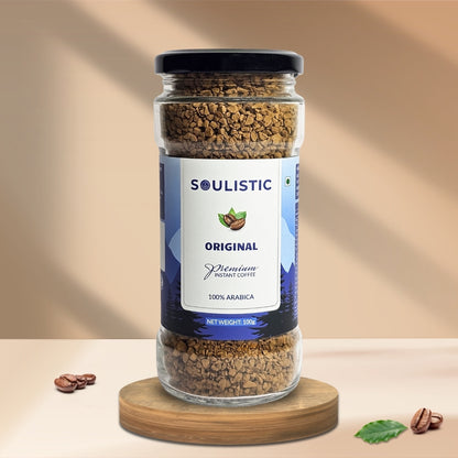 Soulistic instant coffee jar on a wooden coaster with a beige background