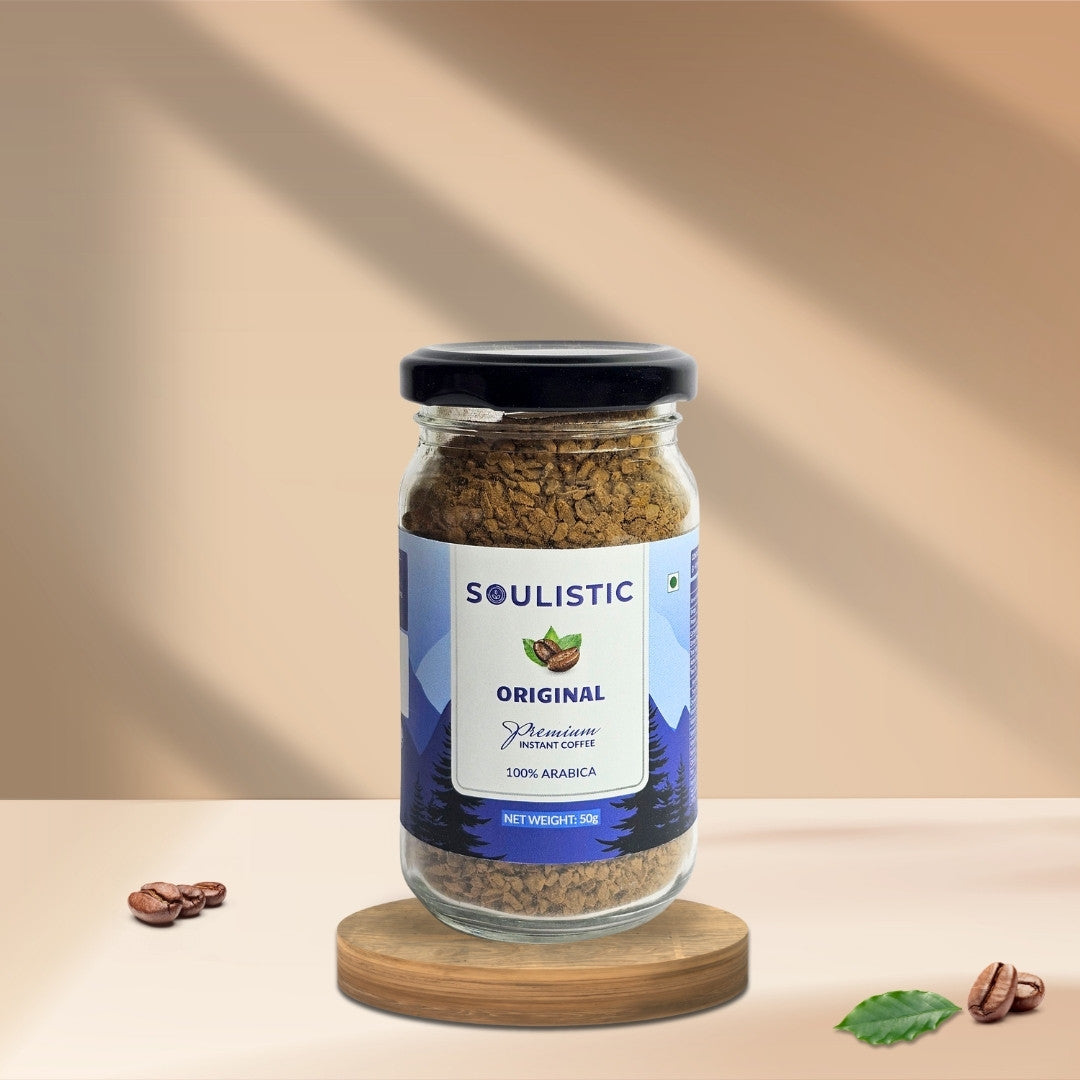 Jar of Soulistic 50g Instant coffee on a wooden coaster with a beige background